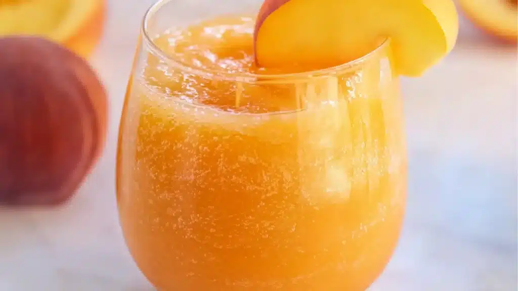 glasses filled with frozen peach lemonade slushies
