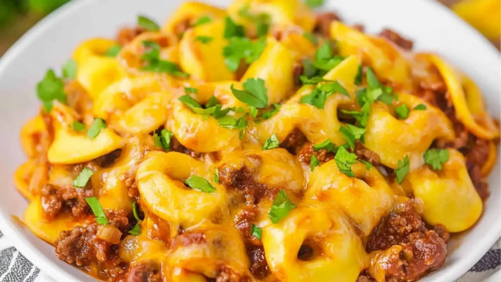 cheesy beef enchilada tortellini in a white bowl
