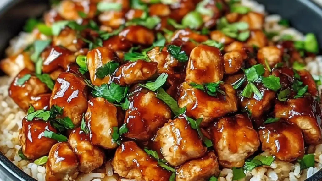 honey bbq chicken rice in a black bowl