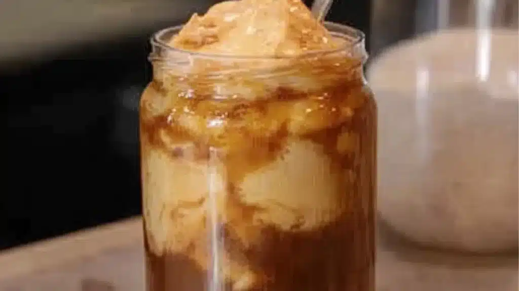 pumpkin spice cold brew with cinnamon and whipped cream in glasses on a white tablecloth