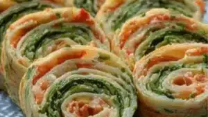 a close up of food on a plate with the words delicious vegetable tortilla roll ups