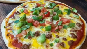 easy mexican pizzas with cheese, black olives, and sour cream on top