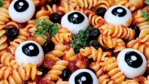Make this creepy-cute Halloween Eyeball Pasta Salad with mozzarella eyes and savory meatballs for your party.
