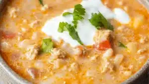 two bowls of white turkey chili with sour cream on top and the words, the best white turkey chili