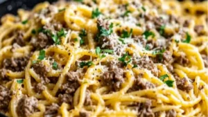 one - pot creamy beef and garlic butter pasta in a skillet with text overlay