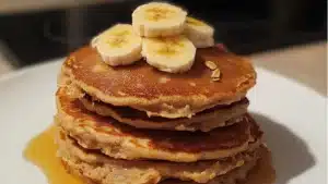 ingredients to make oatmeal are displayed in bowls on a white table top
